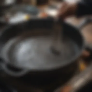 A cast iron pan being gently cleaned with a brush and water