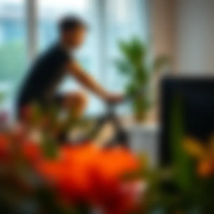 A person cycling on a desk exercise bike while working