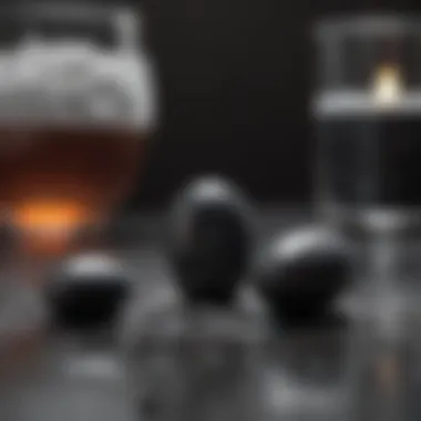 Activated Charcoal Capsules with Water A natural setting showcasing activated charcoal capsules and a glass of water